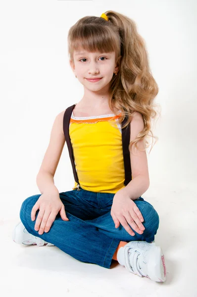 Little girl in jeans on a white background — Stock Photo, Image