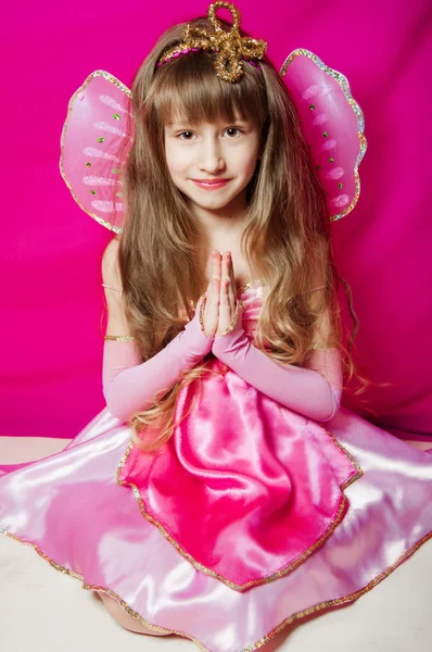 Little girl in a pink dress and wings — Stock Photo, Image