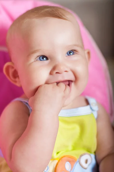 Baby sitting in a chair  and smiling — Stock Photo, Image