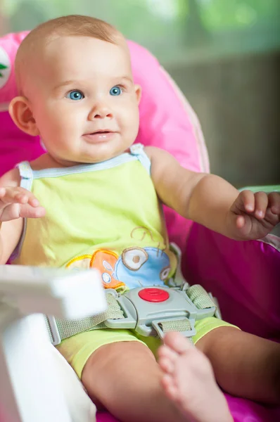 Baby sitting in a chair  and smiling — Stock Photo, Image