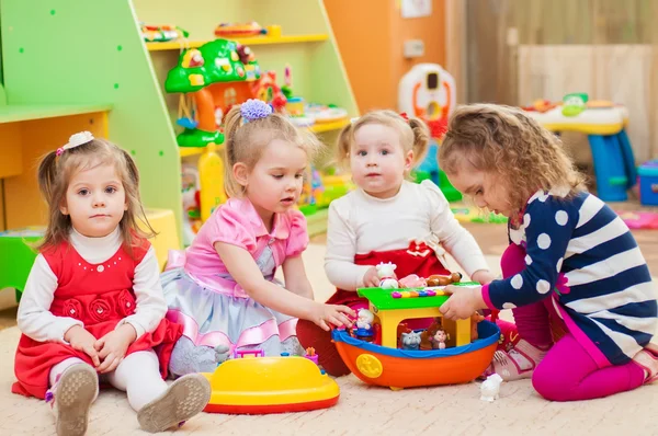 Девочки играют в игрушки в игровой комнате — стоковое фото