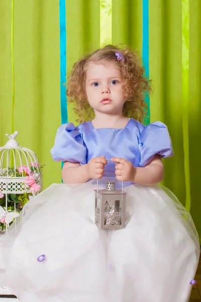 Little girl in a beautiful dress with  birdcages — Stock Photo, Image