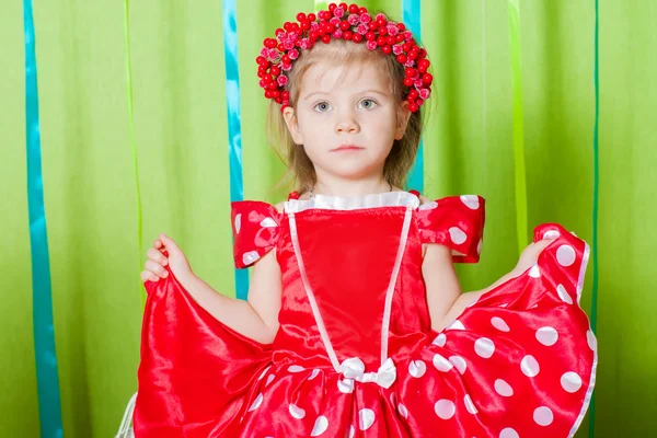 Hermosa chica en un vestido rojo y corona de bayas rojas —  Fotos de Stock