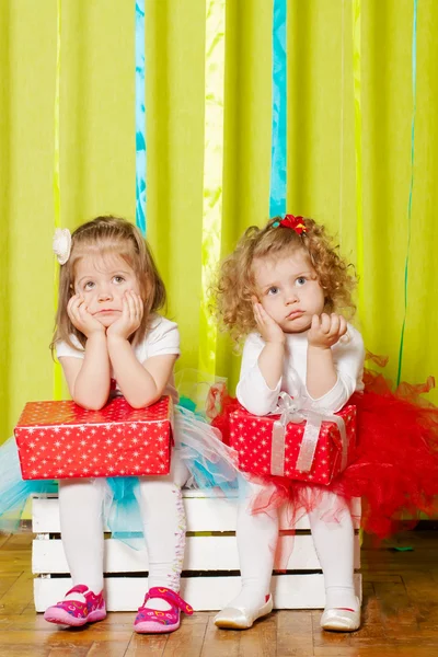 Little girls in fluffy skirts with gift boxes — Stock Photo, Image