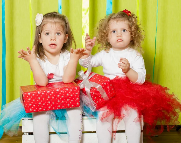 Little girls in fluffy skirts with gift boxes — Stock Photo, Image