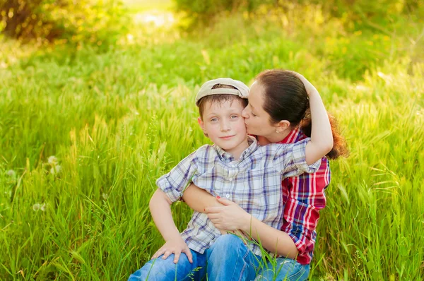 Mom and boy with dandelions in summer — Stock Photo, Image
