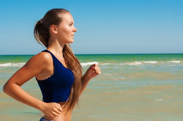 Gadis atlet cantik yang sedang berolahraga di pantai. — Stok Foto