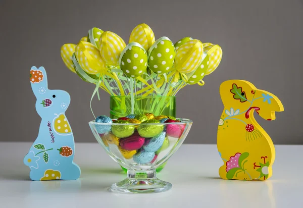 Easter bunnies with eggs and candies — Stock Photo, Image