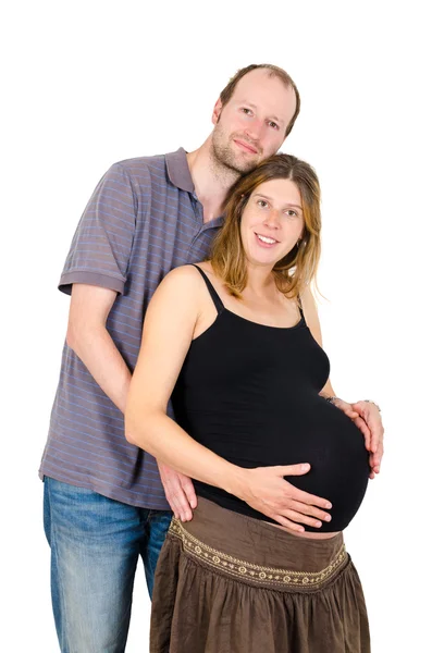 Felice uomo abbracciando bella donna incinta isolato — Foto Stock