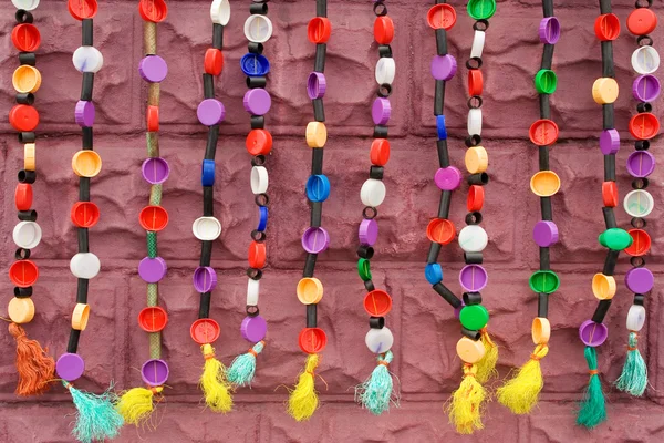 Strings of ethnic beadwork hanging against a wall — Stock Photo, Image