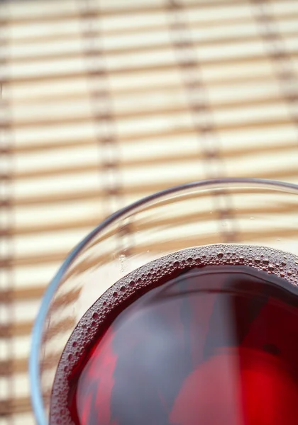 Glass of freshly poured red wine — Stock Photo, Image