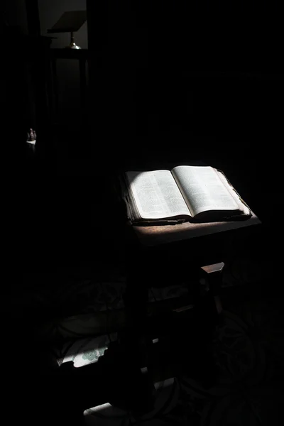 Old open bible lying on a wooden table — Stock Photo, Image