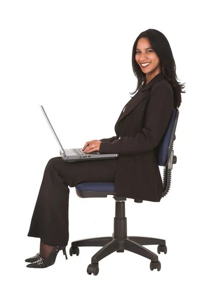 African-Indian businesswoman sitting with a laptop — Stock Photo, Image