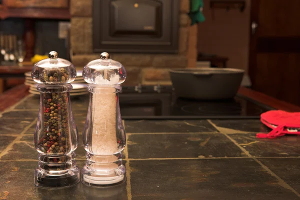 Salt and pepper shaker on a work surface — Stock Photo, Image