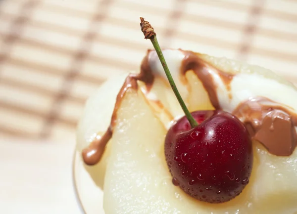 Fresh pear and cherry desert with melted white and milk chocolate topping — Stock Photo, Image