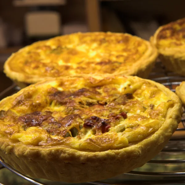 Glazed French Quiche Lorraine in a patisserie — Stock Photo, Image