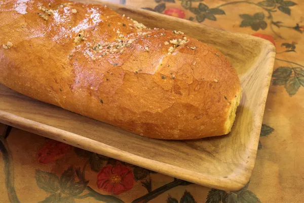 Loaf of bread on wooden board — Stock Photo, Image