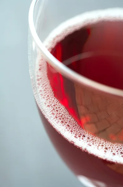 Glass of freshly poured red wine — Stock Photo, Image
