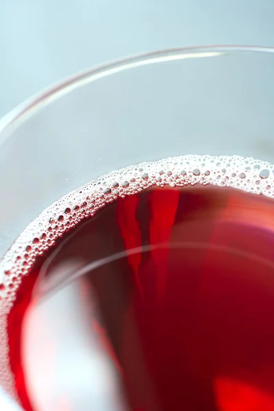 Glass of freshly poured red wine — Stock Photo, Image