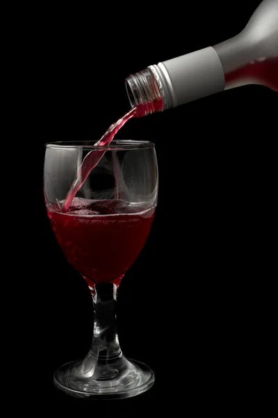 Wine is being poured into a glass — Stock Photo, Image