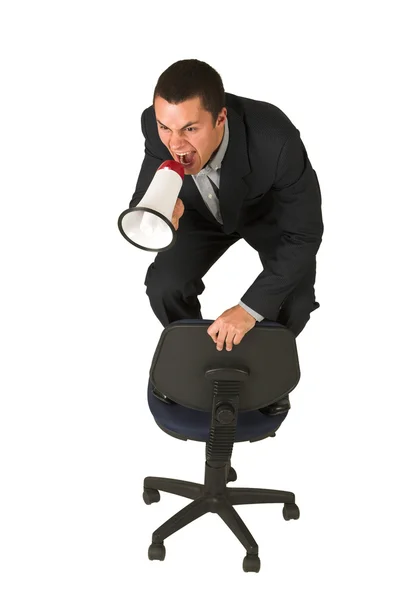 Businessman on an office chair with a megaphone — Stock Photo, Image