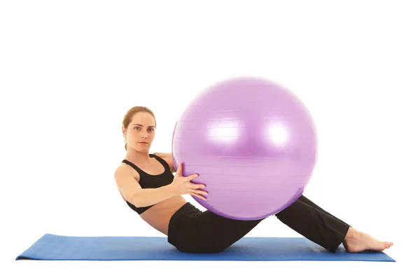 Fit young brunette pilates instructor showing different exercises — Stock Photo, Image