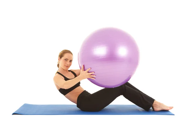 Fit young brunette pilates instructor showing different exercises — Stock Photo, Image