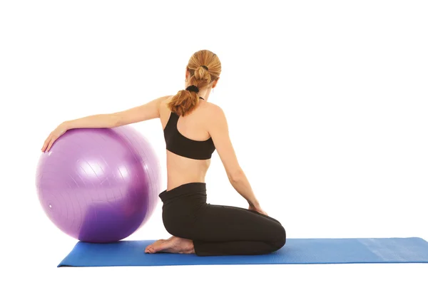 Fit young brunette pilates instructor showing different exercises — Stock Photo, Image