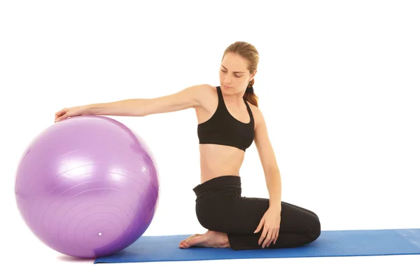 Fit young brunette pilates instructor showing different exercises — Stock Photo, Image