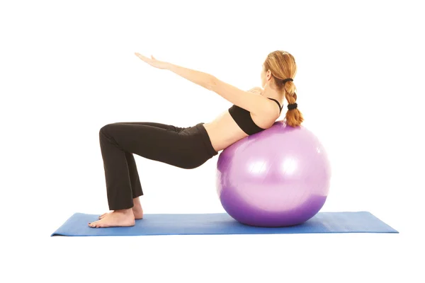 Fit young brunette pilates instructor showing different exercises — Stock Photo, Image