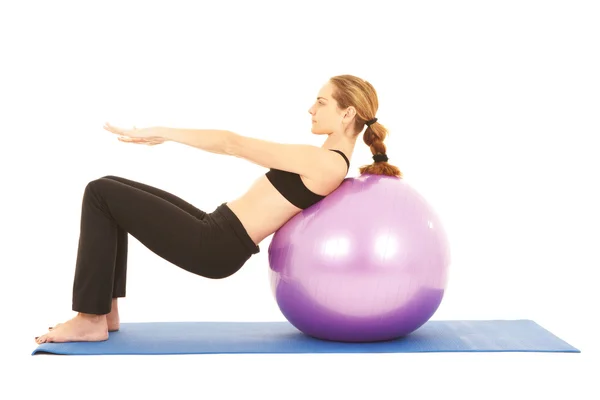 Fit young brunette pilates instructor showing different exercises — Stock Photo, Image