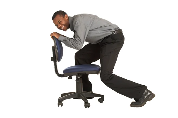 Businessman riding on an office chair — Stock Photo, Image