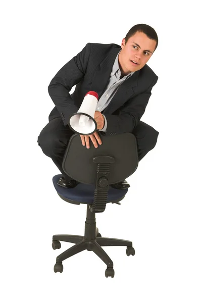 Zakenman op een stoel van het Bureau met een megafoon — Stockfoto