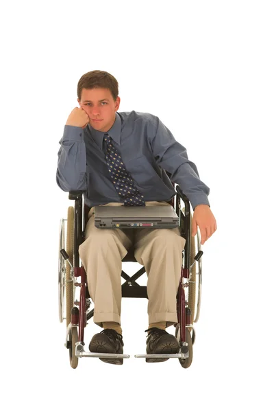 Бизнесмен сидит в инвалидной коляске с ноутбуком — стоковое фото