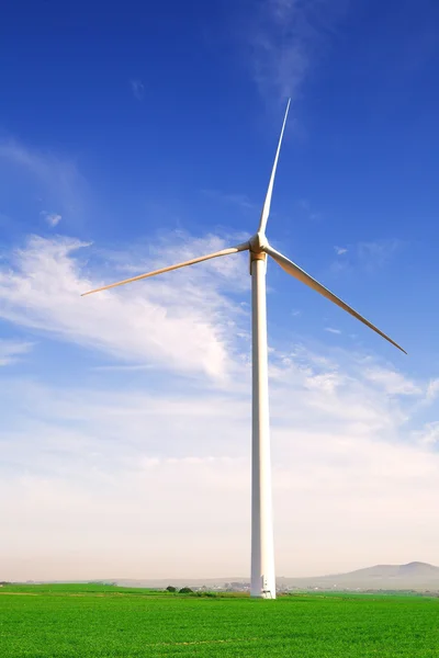Wind powered electricity generator standing against the blue sky — Stock Photo, Image