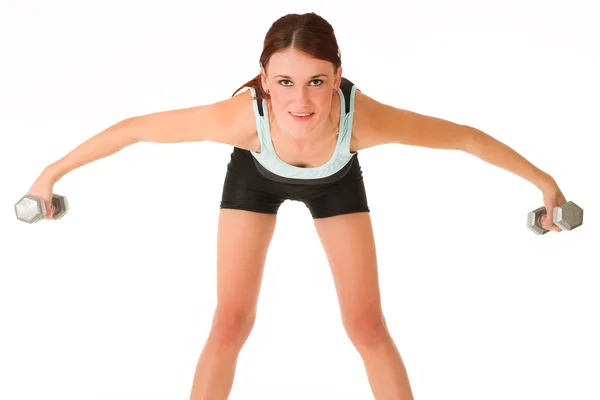 Vrouw permanent, buigen naar voren bedrijf sportschool gewichten in beide handen. — Stockfoto