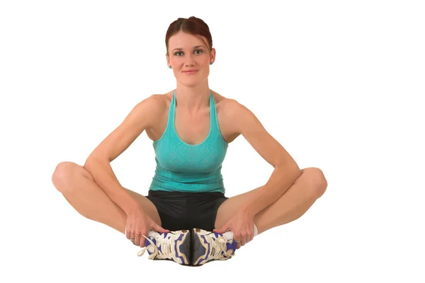 Woman in gym wear holding her feet. — Stock Photo, Image