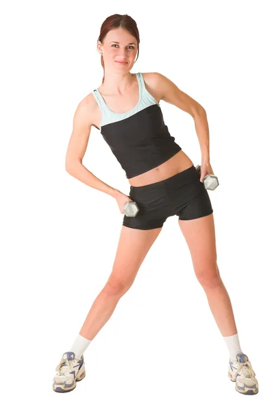 Woman standing, bending forward holding gym weights in both hands. — Stock Photo, Image