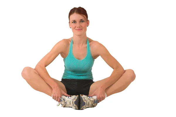 Woman in gym wear holding her feet. — Stock Photo, Image