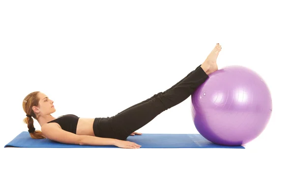 Fit young brunette pilates instructor showing different exercises Stock Image