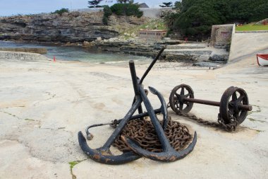 Anchors and anchor chains on Hermanus Harbour, South Africa clipart