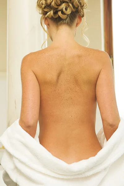 Woman undressing in a bathroom — Stock Photo, Image