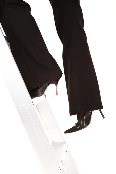 Businesswoman in stilettos climbing the ladder to success — Stock Photo, Image