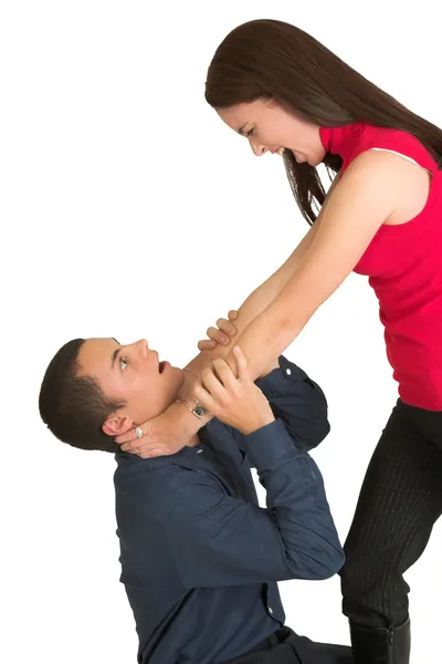 A brunette woman strangling her male business partner. — Stock Photo, Image