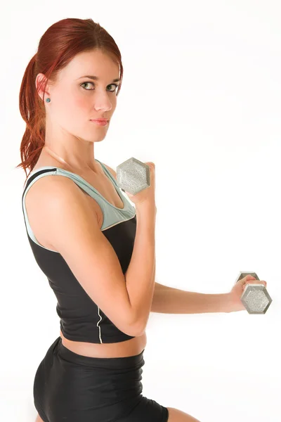 Sexy young adult Caucasian woman in a black training wear with small weights — Stock Photo, Image