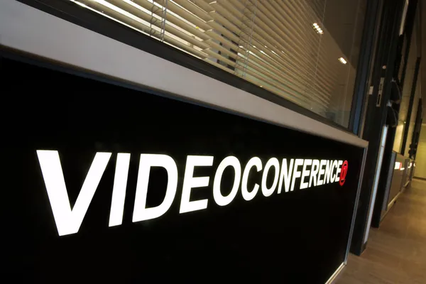 A notice against a wall of an office that reads: Video Conference.
