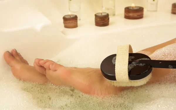Bare feet in a bubble bath — Stock Photo, Image