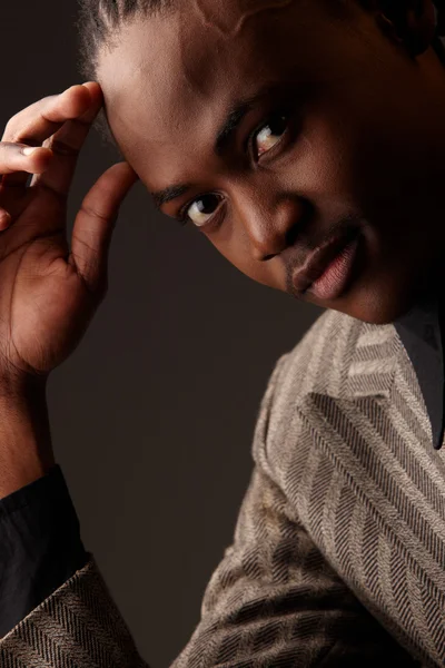 Black African businessman on a dark background — Stock Photo, Image