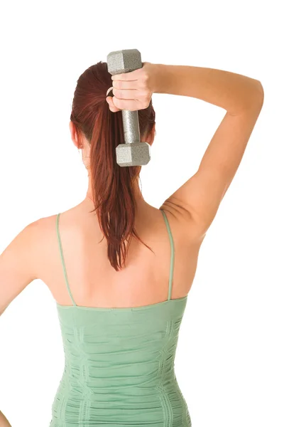 Vrouw met gewicht achter haar rug, witte achtergrond. — Stockfoto