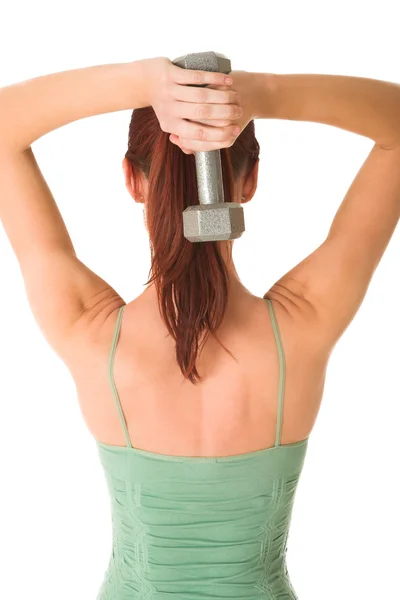 Woman standing with weight behind her back, white background. — Stock Photo, Image